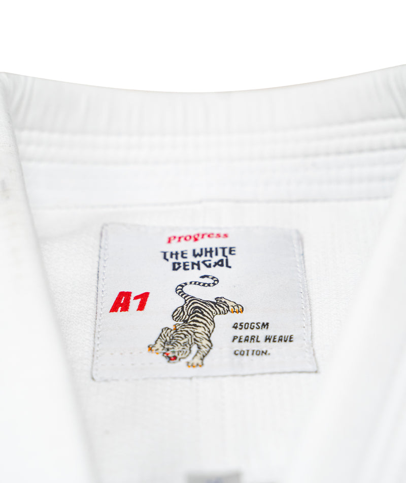 A close up image of the whit Bengal Kimono tag containing the brand name and size.