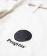 A close up view of the White Ladies M6 Kimono Mark 5 pants Progress logo embroidery