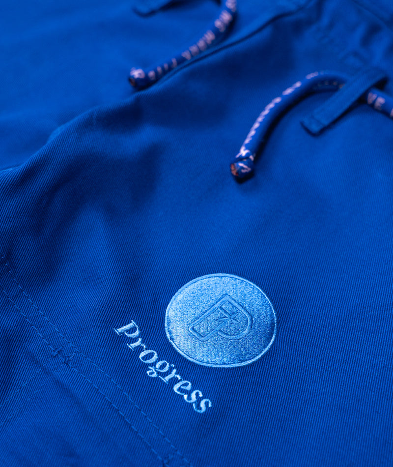 A close up view of the Blue Ladies M6 Kimono Mark 5 pants Progress logo embroidery