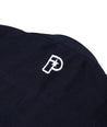 Close up view of the Progress logo embroidery on the back of the navy blue The Temple Kimono